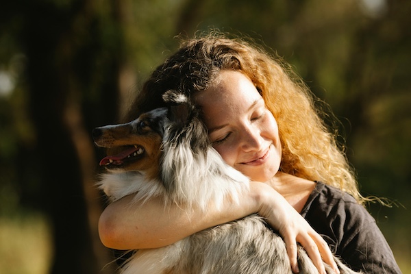 Are you a Pet Lover? Woman hugging her Sheltie dog sure is.